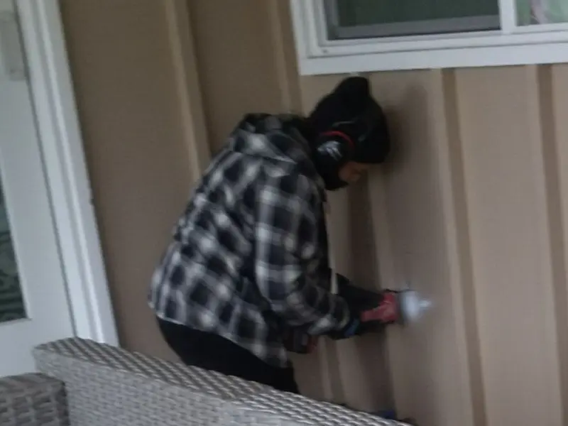 Professional electrician installing an exterior outlet in River Road
